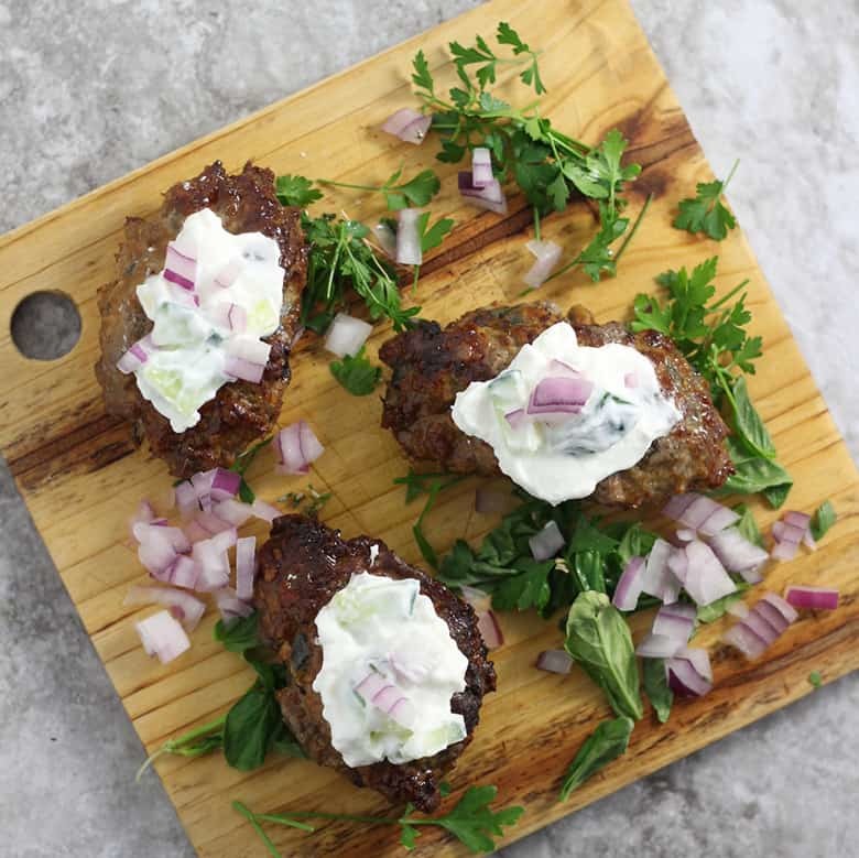 Middle Eastern Lamb Koftas with Hummus and Yogurt Sauce. A classic Middle Eastern recipe that is great home cooks.