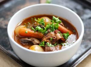 Boeuf Bourguignon | A classic French beef stew made easy. This easy beef stew develops its flavor from many layers, onions, mushrooms, carrots, bacon, beef, red wine, broth, garlic, bay leaf and thyme.