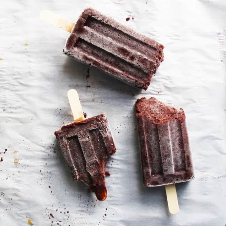 Black Forrest Popsicles with Dark Chocolate Almond Milk. A decadent but healthy Summer Popsicle recipe. Dark chocolate almond milk, extra cocoa and dark cherries make for a rich, chocolatey guilt-free dessert. You are welcome! | FusionCraftiness.com