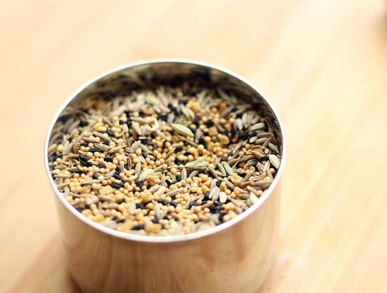 Panch Phoran spice blend in a small cup.