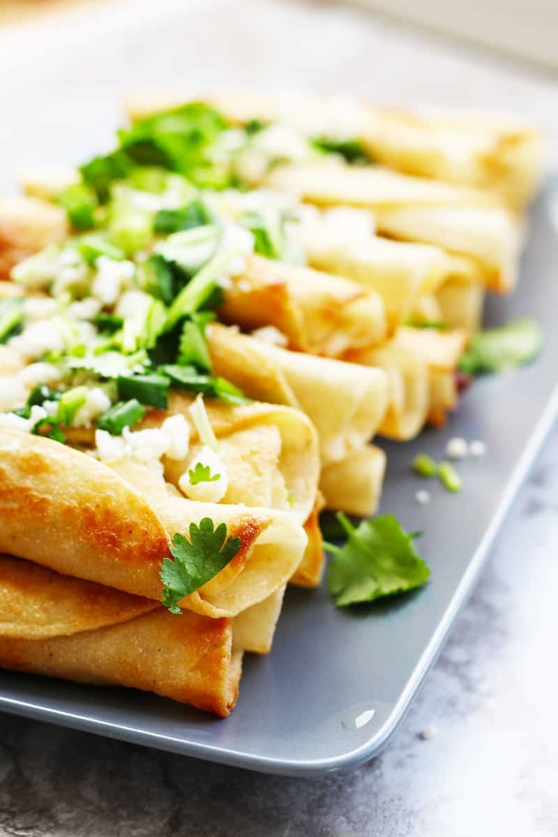 Easy Traditional Chicken Flautas Recipe. Just make your simple chicken filling, scoop on a corn tortilla, roll and shallow fry until golden brown. Serve with your favorite Latin American garnishes like salsa, guac, sour cream, cilantro & cheese.