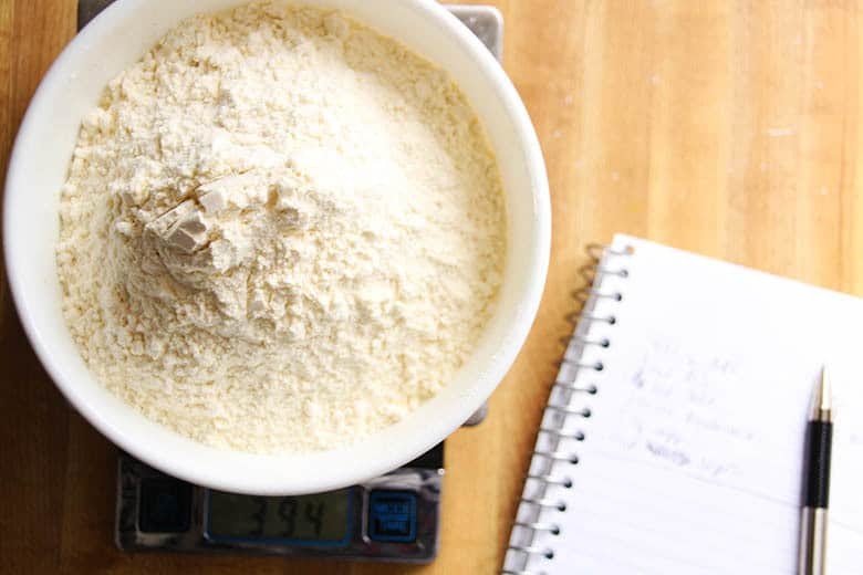A bowl of flour on a scale.