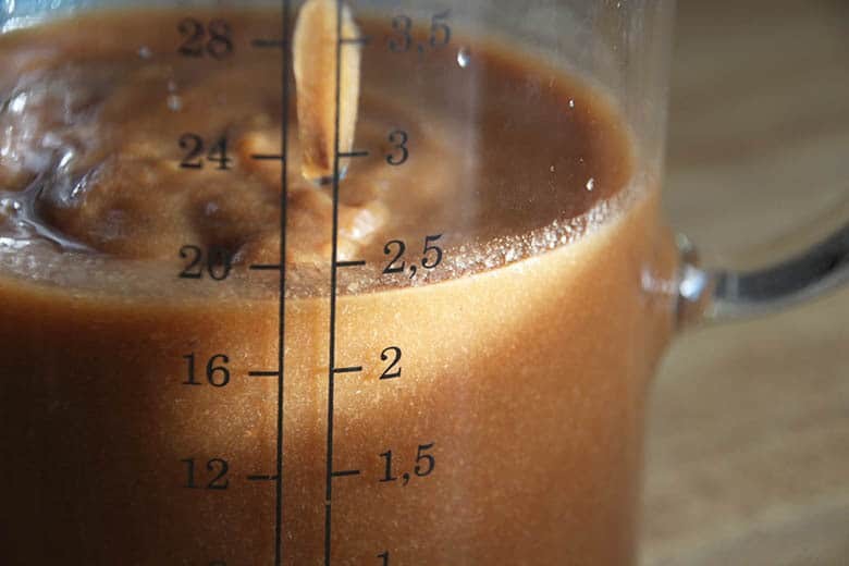 A measuring cup of tamarind paste.