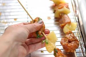 Chicken and pineapple placed on skewers.