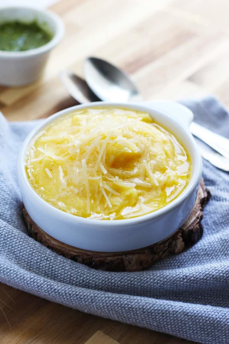 A bowl of polenta with parmesan on top.