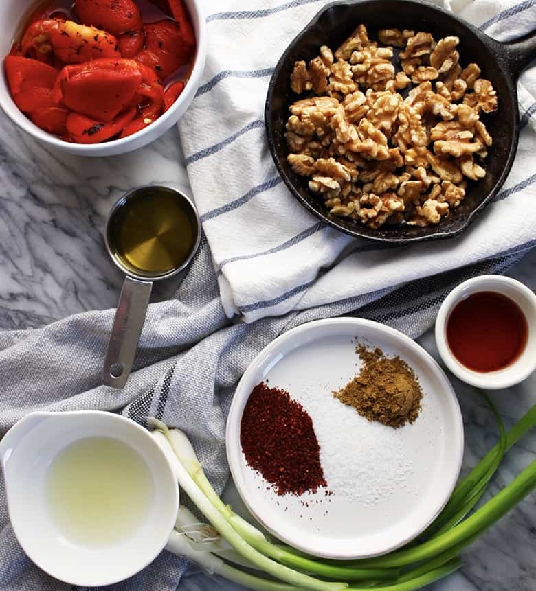 Ingredients for Muhammara on a marble counter.