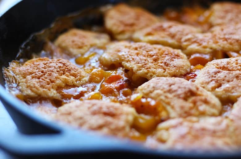 Cast iron skillet with peach cobbler.