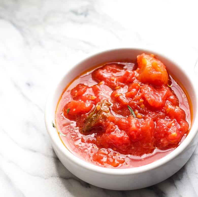 Tomato relish in a white bowl.