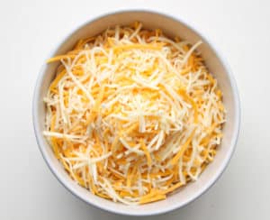 Shredded cheese in a bowl.