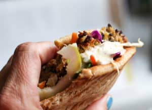 A mackerel and slaw flatbread sandwich with remoulade spicy mayo.