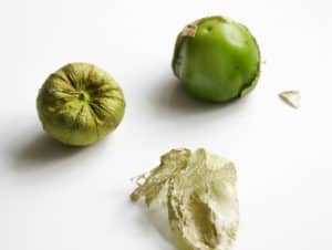 Tomatillos both peeled and unpeeled.