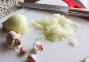 Onions and garlic on cutting board.