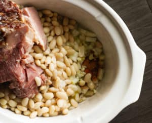 Crockpot with spices, beans and smoked ham.