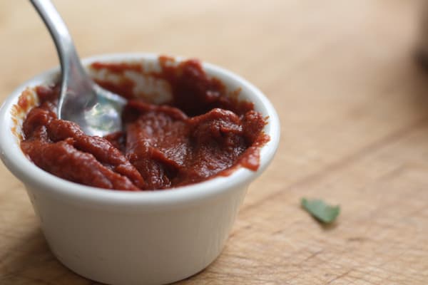 A small bowl with tomato paste.