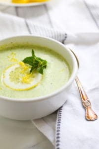 Zucchini soup in a white bowl.