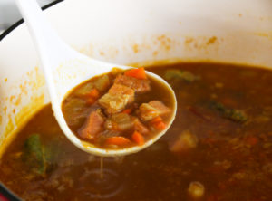 Lentil soup in large pot simmering.