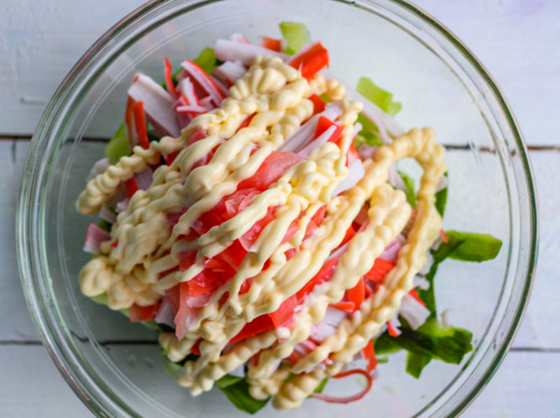 A bowl of Kani Salad ingredients with mayo.