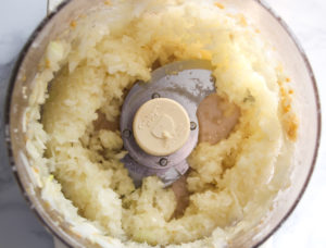 Chopped onions and garlic in food processor.