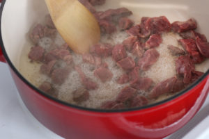 Beef browning in pot.