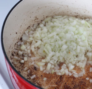 Diced onions cooking in pot.